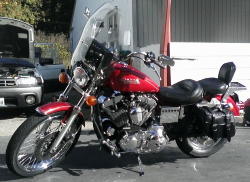 Harley Davidson Sportster with black leather rear seat and chrome luggage rack